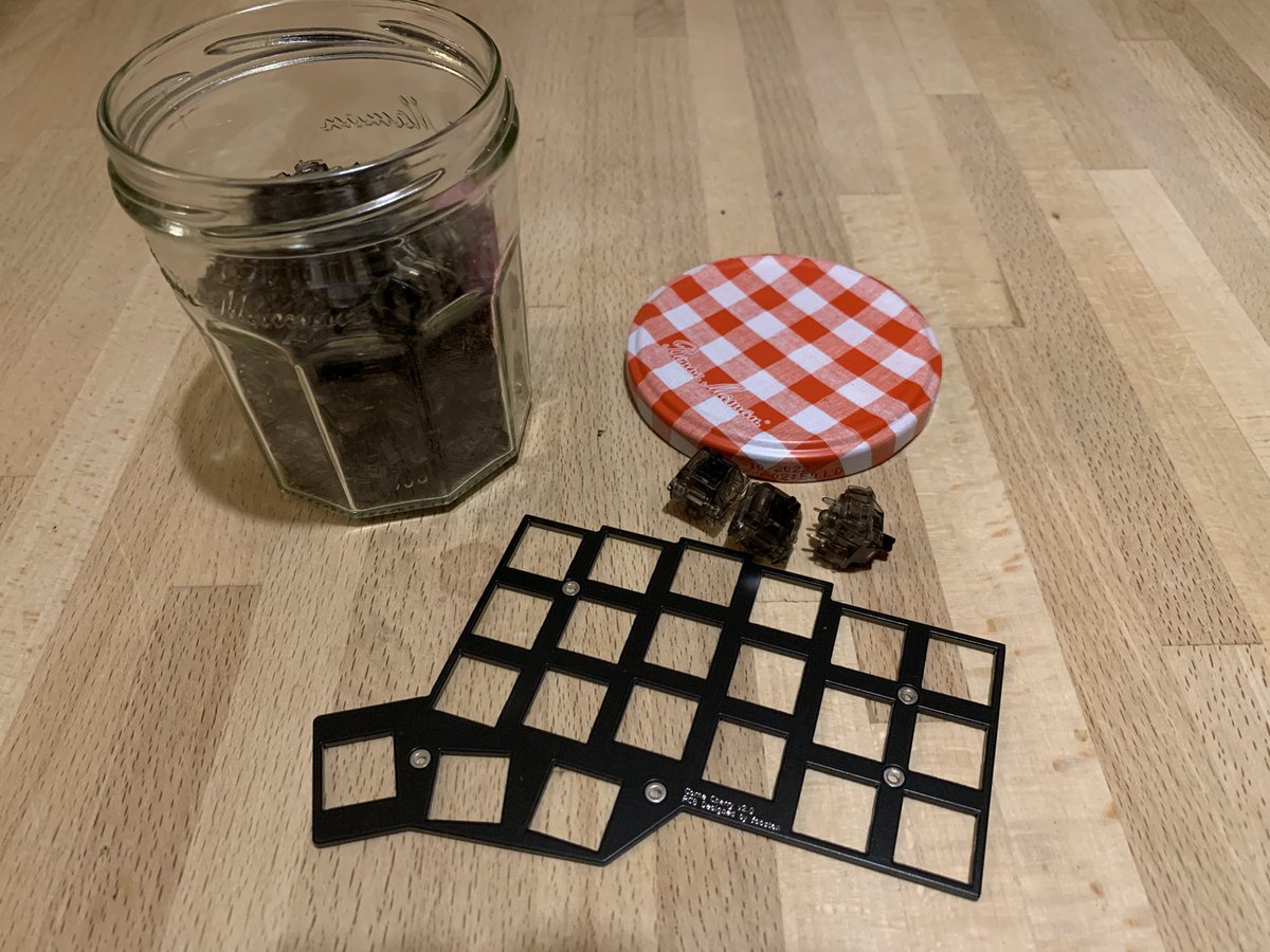 A jam jar full of key switches and an empty switch plate